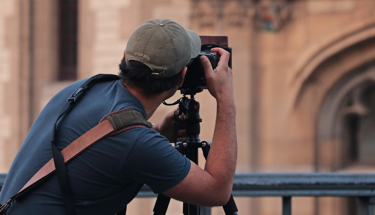 Man Taking a Photo in the City